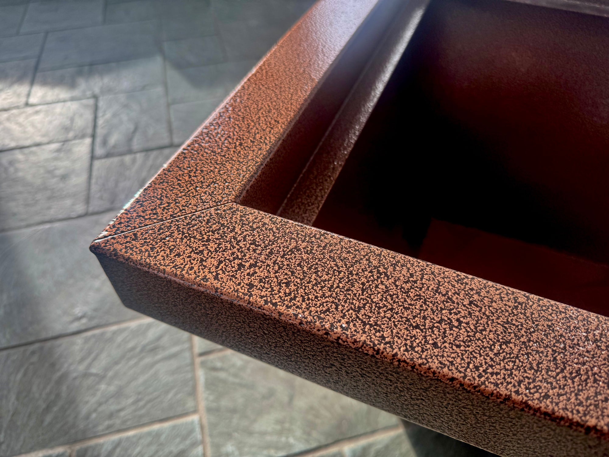 Close-up of powder coating process for durable custom metal finishing at HM Metalworks