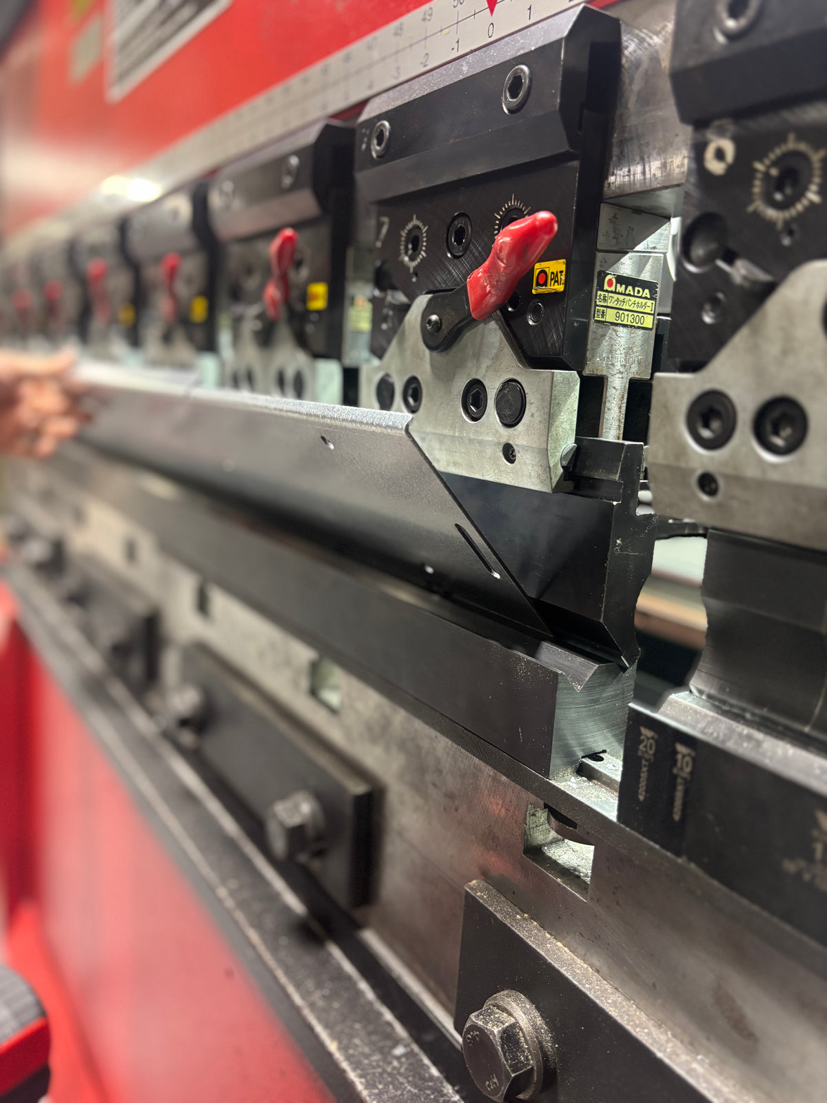 Press brake bending galvanized steel sheet for custom metal fabrication at HM Metalworks