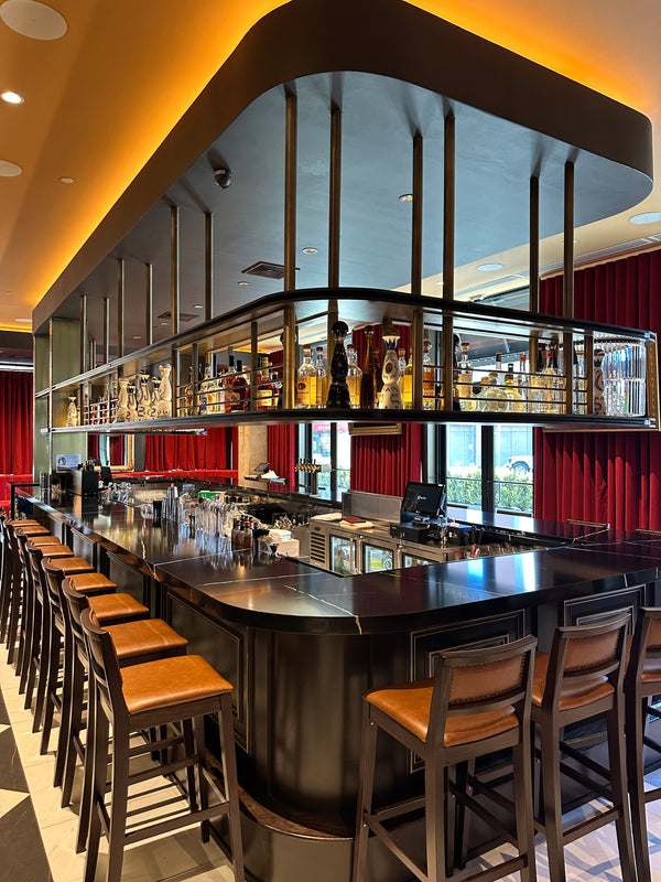 Custom overhead metal shelving wrapping around bar top for commercial buildout by HM Metalworks