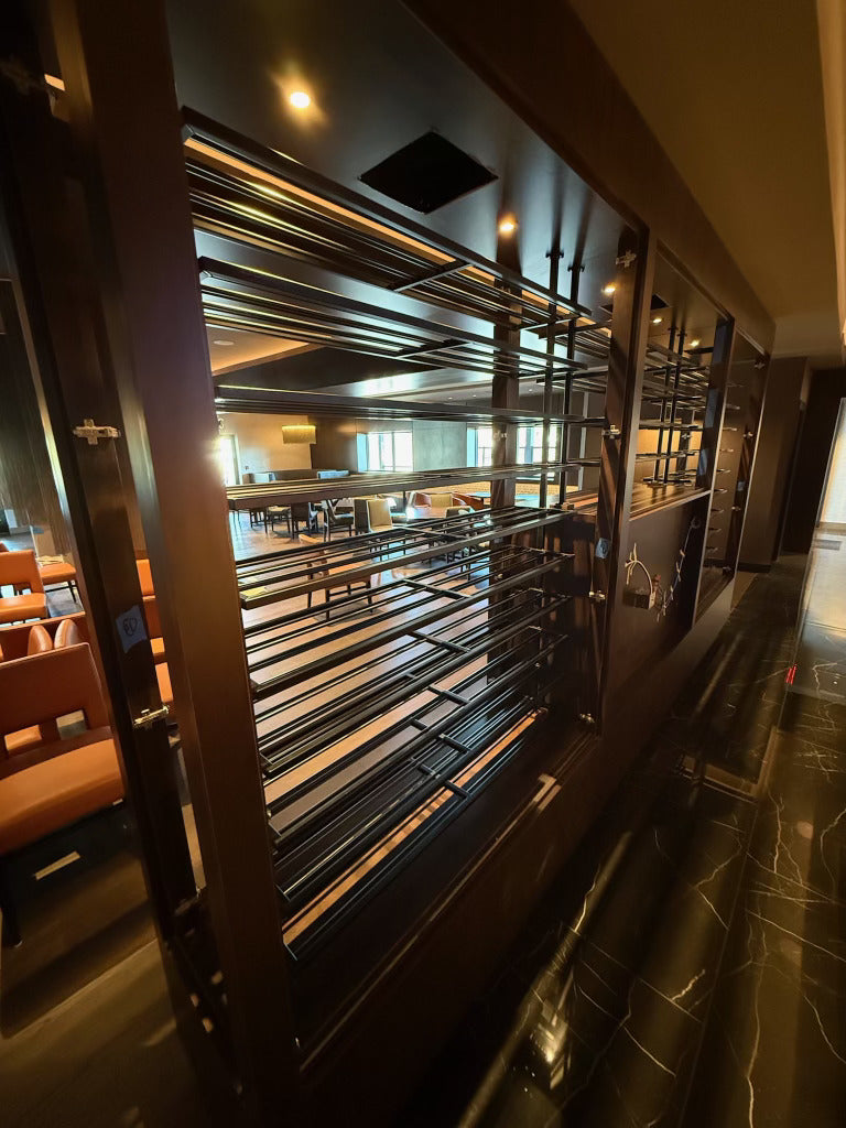 Close view of the metal wine rack rails at Masseria Italian Steakhouse, built by HM Metalworks