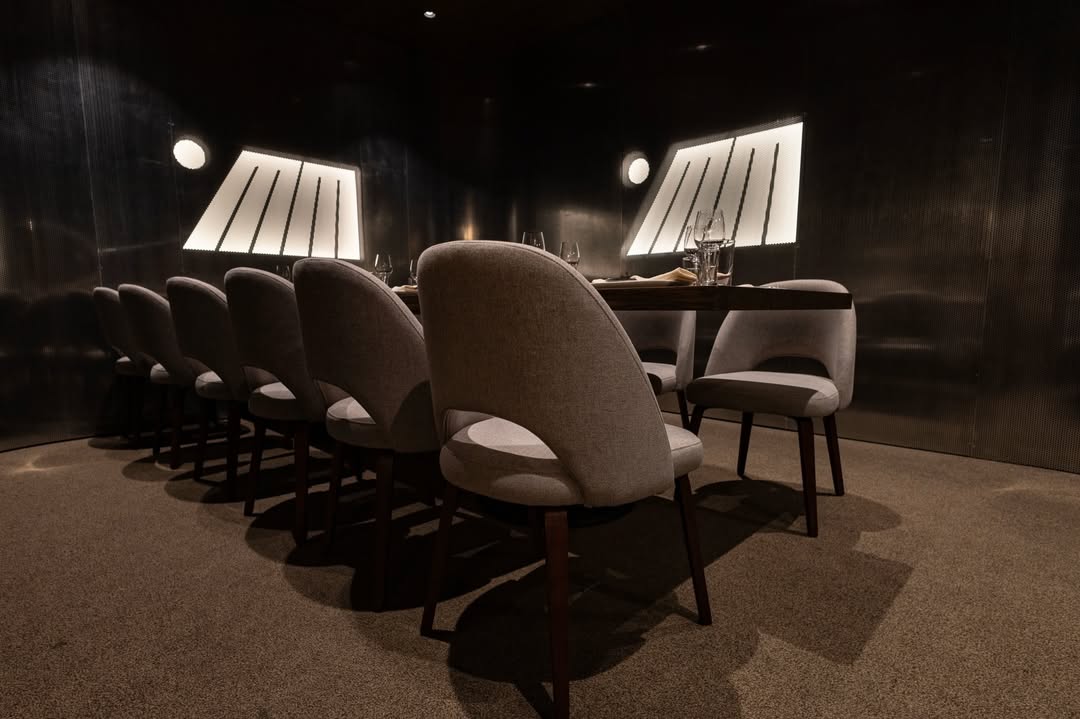 Curved perforated metal wall panels in a dining room at MM by Morimoto in Montclair, NJ, built by HM Metalworks