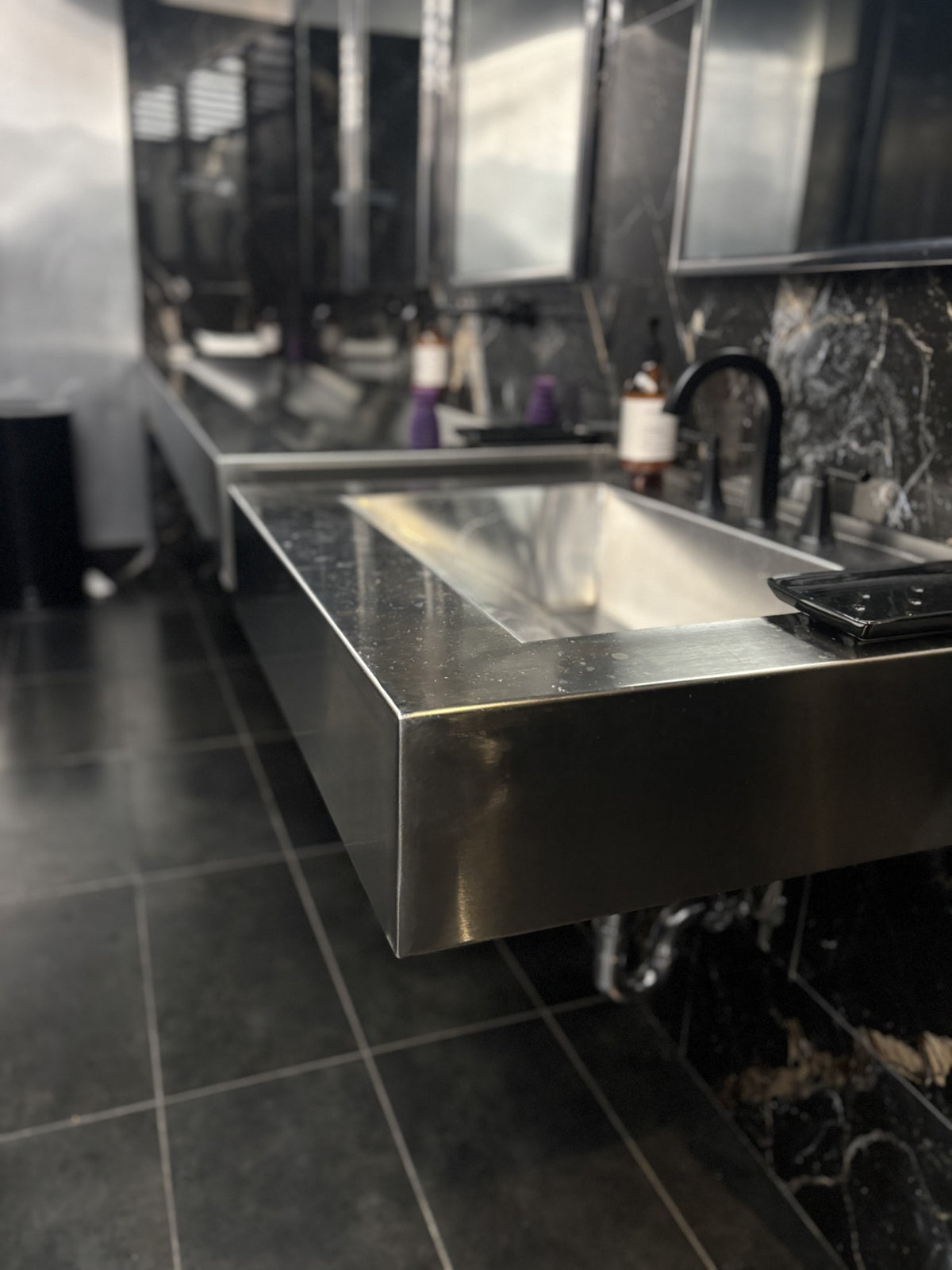 Wall hung stainless steel trough sink at MM by Morimoto in Montclair, NJ, built by HM Metalworks