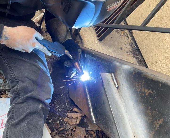 On-site welding of exterior stairwell structure for commercial metal fabrication by HM Metalworks